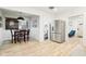 Open floor plan with dining table, stainless steel fridge and view to a blue chair at 546 E Merrill St, Indianapolis, IN 46203