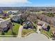 Aerial view of a beautiful home nestled in a scenic neighborhood with lush greenery and manicured lawns at 5517 Westbourne Ct, Greenwood, IN 46143