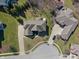 Expansive home with well-manicured lawn, mature trees, and a circular driveway in a serene neighborhood at 5517 Westbourne Ct, Greenwood, IN 46143