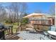 Outdoor back deck with wicker seating, a grill, and an umbrella, perfect for outdoor relaxation and dining at 5517 Westbourne Ct, Greenwood, IN 46143