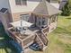 Inviting back deck perfect for outdoor dining, complete with furniture, grill, and access to the home at 5517 Westbourne Ct, Greenwood, IN 46143