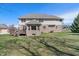 Large, well-maintained backyard with a brick home featuring a deck, patio, and ample space for recreation at 5517 Westbourne Ct, Greenwood, IN 46143