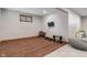 Finished basement with wood-look floors, exercise equipment, and a versatile area for various activities at 5517 Westbourne Ct, Greenwood, IN 46143