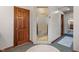 Walk-in shower with glass door, beige tiling, and an open doorway to another bathroom at 5517 Westbourne Ct, Greenwood, IN 46143
