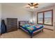 Cozy bedroom featuring a ceiling fan, natural light, and a comfortable bed with a colorful quilt at 5517 Westbourne Ct, Greenwood, IN 46143