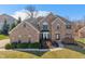 Stately two-story brick home featuring manicured landscaping and a welcoming entrance at 5517 Westbourne Ct, Greenwood, IN 46143