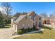 Gorgeous brick home featuring an attached garage and well-manicured lawn and landscaping at 5517 Westbourne Ct, Greenwood, IN 46143