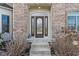 Close-up of an elegant front door with decorative glass and meticulous landscaping at 5517 Westbourne Ct, Greenwood, IN 46143