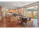 Eat-in kitchen with wood cabinets, granite counters, stainless appliances, and a view to the sunroom at 5517 Westbourne Ct, Greenwood, IN 46143