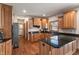 Well-equipped kitchen featuring granite countertops, stainless steel appliances, and wood cabinets at 5517 Westbourne Ct, Greenwood, IN 46143