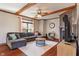 Inviting living room with a cozy fireplace, wood beam ceiling, and comfortable sectional sofa at 5517 Westbourne Ct, Greenwood, IN 46143