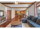 Open-concept living room flows into a modern kitchen with a large sectional sofa at 5517 Westbourne Ct, Greenwood, IN 46143