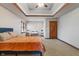 Cozy bedroom features a tray ceiling, ceiling fan and a double-hung window at 5517 Westbourne Ct, Greenwood, IN 46143