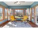 Bright sunroom with natural light, comfortable seating, and views of the backyard at 5517 Westbourne Ct, Greenwood, IN 46143