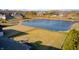 Stunning aerial view of property with a serene pond, bordered by a classic fence, in a lovely neighborhood at 5842 Oakmont Blvd, Bargersville, IN 46106