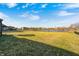 Expansive backyard with grass lawn and a beautiful pond view, creating a serene and private outdoor space at 5842 Oakmont Blvd, Bargersville, IN 46106
