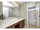 Bathroom features an extended vanity with a large mirror, neutral walls and view to an adjoining shower area at 5842 Oakmont Blvd, Bargersville, IN 46106