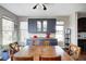 Dining area with cabinetry, large table, natural lighting, and access to the kitchen at 5842 Oakmont Blvd, Bargersville, IN 46106