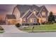 Spacious home with a brick facade, three car garage, and manicured landscaping at 5842 Oakmont Blvd, Bargersville, IN 46106