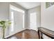 Bright foyer with hardwood floors, a decorative table, and a large windowed front door at 5842 Oakmont Blvd, Bargersville, IN 46106