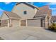 Attached three-car garages with brick and vinyl siding offer ample parking space at 5842 Oakmont Blvd, Bargersville, IN 46106