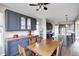 Bright kitchen with a wooden table, blue cabinets, and stainless steel appliances at 5842 Oakmont Blvd, Bargersville, IN 46106