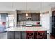 Gourmet kitchen with granite island, pendant lighting, and dark wood cabinetry at 5842 Oakmont Blvd, Bargersville, IN 46106