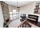 Open living room with stone fireplace, large windows, and view of the kitchen at 5842 Oakmont Blvd, Bargersville, IN 46106