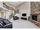Open-concept living space with staircase, stone fireplace, and soaring ceilings at 5842 Oakmont Blvd, Bargersville, IN 46106