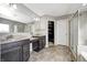 Main bathroom with double sinks, spacious tile flooring, and a walk-in closet at 5842 Oakmont Blvd, Bargersville, IN 46106