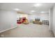 Unfinished basement featuring carpet, drop ceiling, and tv area at 6144 Maple Branch Pl, Indianapolis, IN 46221