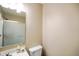 Bright bathroom featuring a glass shower door, white toilet, and vanity with soap dispenser at 6144 Maple Branch Pl, Indianapolis, IN 46221