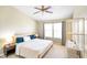 Bright bedroom with ceiling fan, large windows, bedside tables, and a large bed at 6144 Maple Branch Pl, Indianapolis, IN 46221
