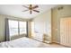 Bright bedroom with cathedral ceiling, white dresser, fan, large windows, and a large bed at 6144 Maple Branch Pl, Indianapolis, IN 46221