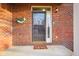 Charming front door with decorative wreath and welcome mat on a brick porch at 6144 Maple Branch Pl, Indianapolis, IN 46221