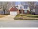 Beautiful two-story home with a brick and vinyl exterior and well-manicured lawn at 6144 Maple Branch Pl, Indianapolis, IN 46221
