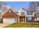 Two-story home with brick and siding, showcasing a well-kept front yard at 6144 Maple Branch Pl, Indianapolis, IN 46221