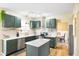 Bright kitchen features an island, modern appliances, painted cabinetry, and stylish backsplash at 6144 Maple Branch Pl, Indianapolis, IN 46221