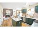 Open-concept kitchen with modern appliances, center island, and seamless flow to the living area at 6144 Maple Branch Pl, Indianapolis, IN 46221