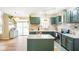 Spacious kitchen with painted cabinets, stainless appliances, island, and great natural lighting at 6144 Maple Branch Pl, Indianapolis, IN 46221