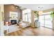 Bright living room with vaulted ceilings, fireplace, large windows, and sliding door access at 6144 Maple Branch Pl, Indianapolis, IN 46221