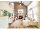 Spacious living room with fireplace, vaulted ceilings, large windows, and ample seating at 6144 Maple Branch Pl, Indianapolis, IN 46221