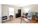 Bright home office featuring built in shelves, two modern chairs, and large desk at 6144 Maple Branch Pl, Indianapolis, IN 46221