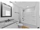 Bathroom featuring modern vanity, granite countertop, and a tub with shower at 617 W 39Th St, Indianapolis, IN 46208