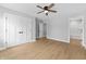 Spacious bedroom featuring light wood floors, a ceiling fan, and ensuite bath at 617 W 39Th St, Indianapolis, IN 46208