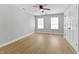 Bedroom with neutral walls, wood flooring, ceiling fan, and natural light at 617 W 39Th St, Indianapolis, IN 46208
