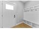 Entryway featuring a built-in mudroom bench with storage and a modern front door at 617 W 39Th St, Indianapolis, IN 46208