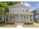 Charming gray two-story home with a welcoming front porch and white trim at 617 W 39Th St, Indianapolis, IN 46208