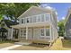Charming gray two-story home with a welcoming front porch and white trim at 617 W 39Th St, Indianapolis, IN 46208
