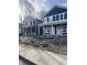 View of two new home builds, one navy and white, the other in grey construction wrap at 617 W 39Th St, Indianapolis, IN 46208